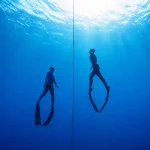 Freedivers training on a depht line in South Fuerteventura